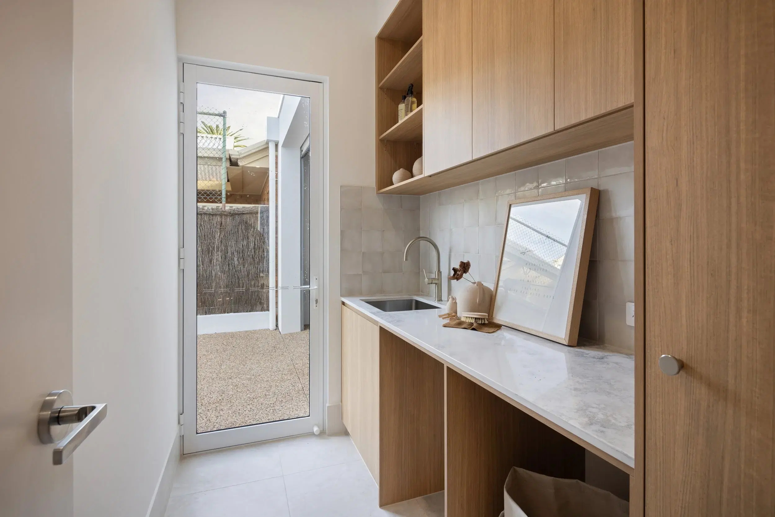 Timber entry joinery with open shelves, bench and concealed storage