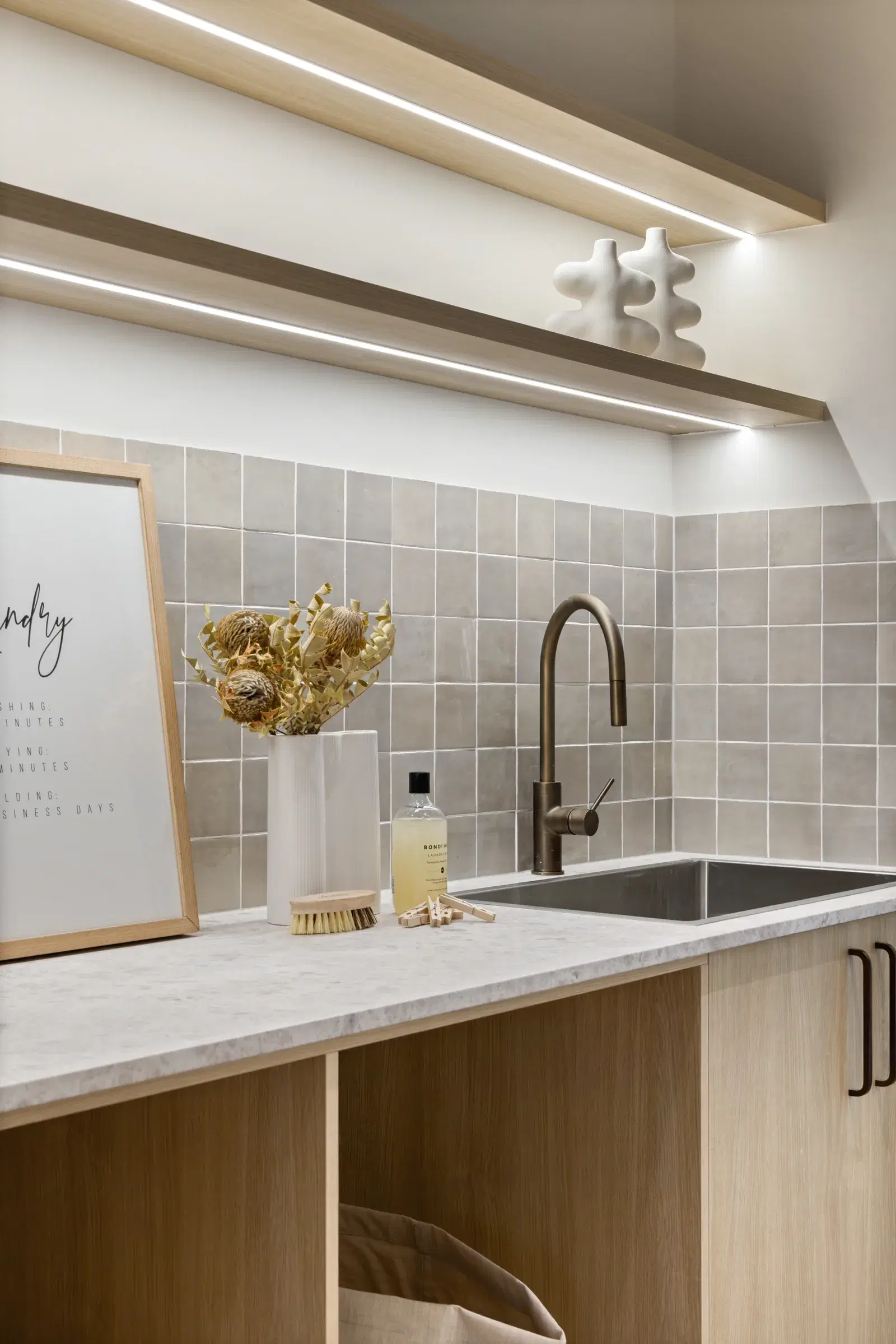 Laundry joinery with timber cabinetry, stone worktop and open shelf